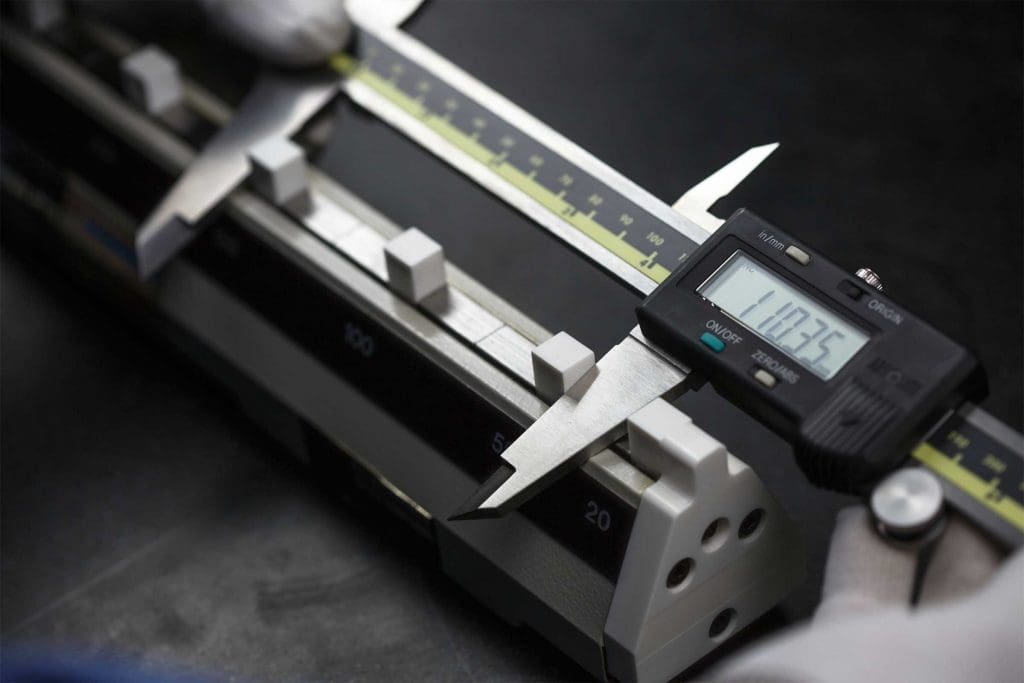 Digital caliper measuring a precision-machined part